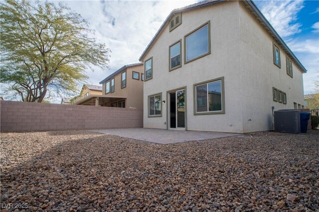 rear view of property featuring central AC and a patio area