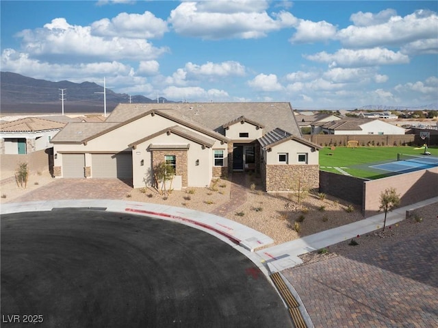 view of front facade with a mountain view and a garage