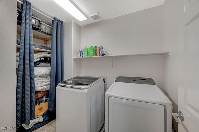 laundry room with separate washer and dryer