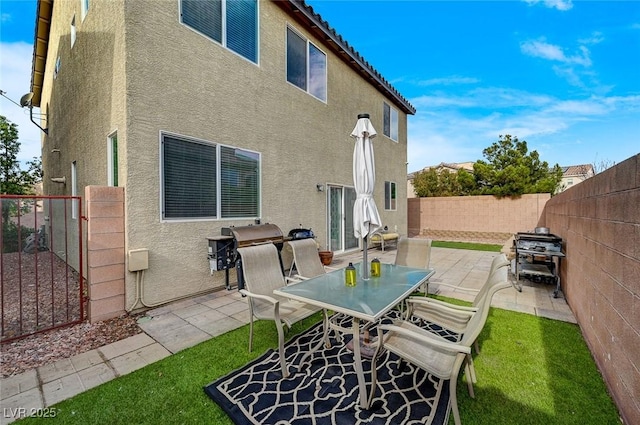 back of house featuring a yard and a patio