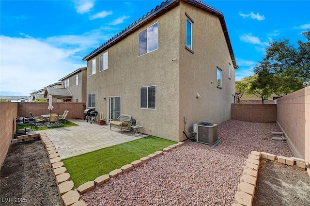 rear view of house with a patio area and central air condition unit