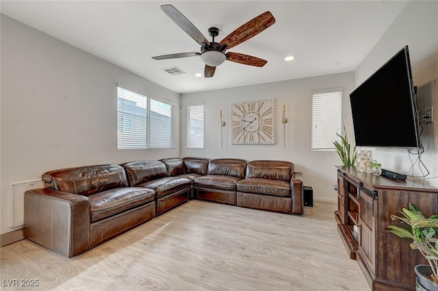 living room with ceiling fan and light wood-type flooring