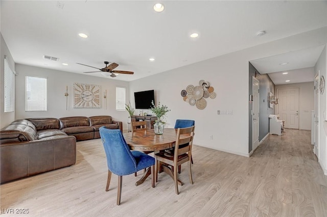 dining area with ceiling fan and light hardwood / wood-style floors