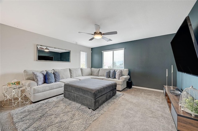 carpeted living room with ceiling fan