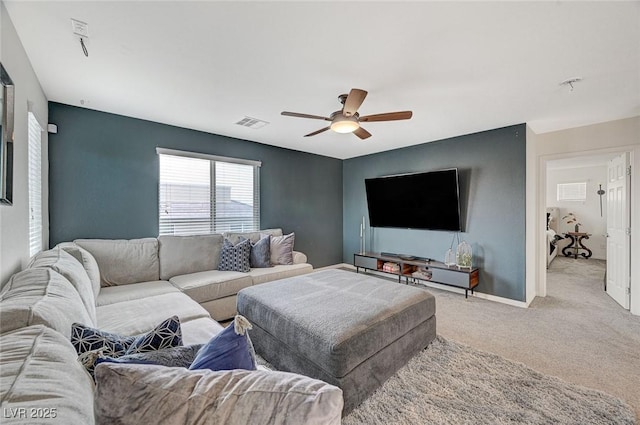 carpeted living room featuring ceiling fan