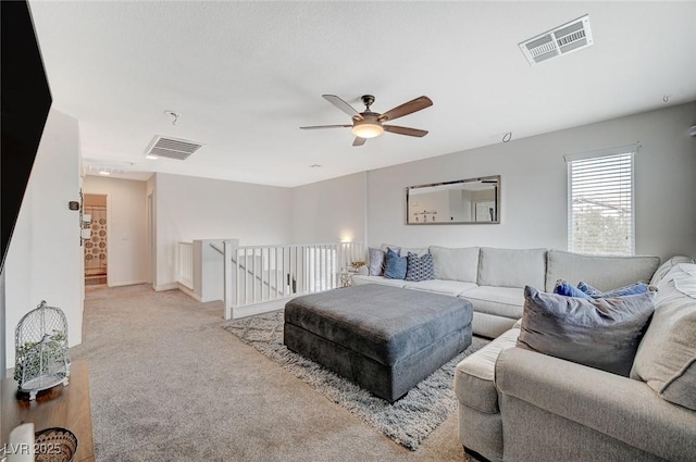 living room featuring ceiling fan and light colored carpet