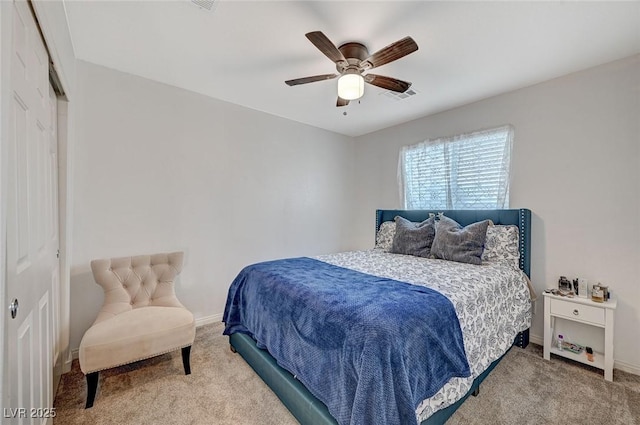 carpeted bedroom featuring ceiling fan and a closet