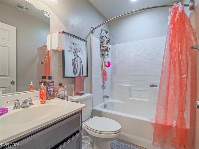 full bathroom with shower / tub combo with curtain, vanity, and toilet