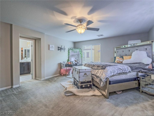 carpeted bedroom featuring a textured ceiling, ceiling fan, and ensuite bathroom