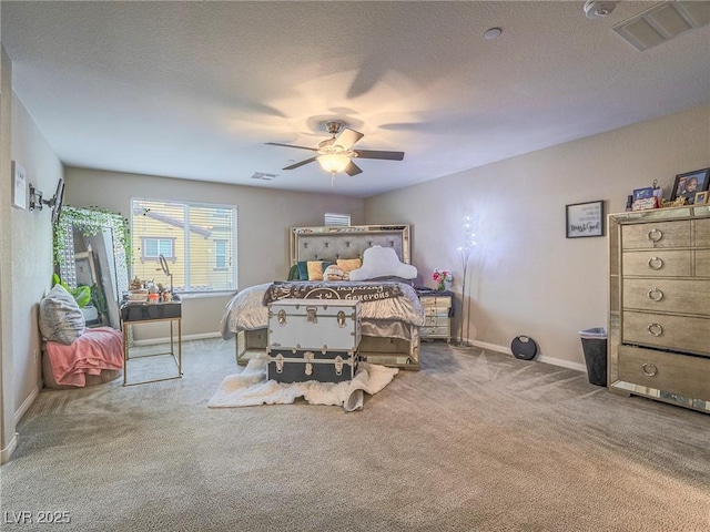 bedroom featuring ceiling fan, carpet flooring, and a textured ceiling