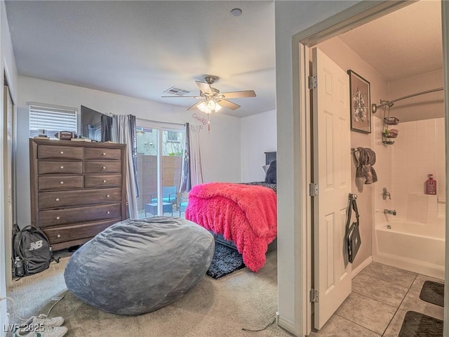 bedroom featuring access to exterior, light tile patterned floors, and ceiling fan