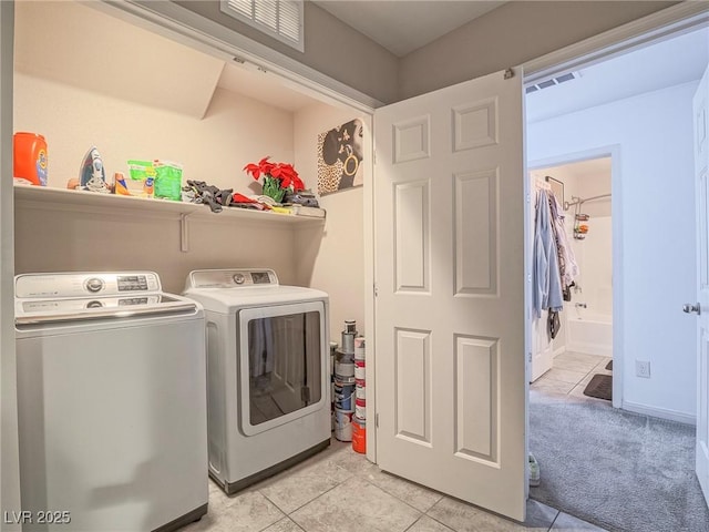 washroom with light tile patterned flooring and separate washer and dryer