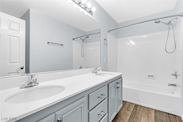 bathroom with vanity, hardwood / wood-style flooring, and bathing tub / shower combination