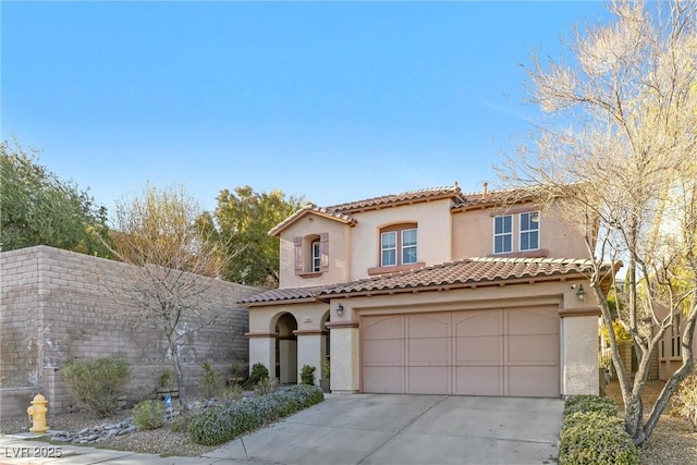 mediterranean / spanish home with a garage