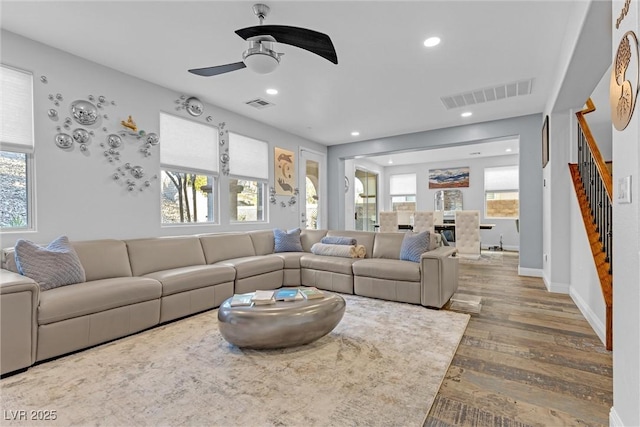 living room with ceiling fan, wood-type flooring, and a healthy amount of sunlight