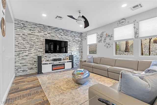 living room with hardwood / wood-style flooring and ceiling fan