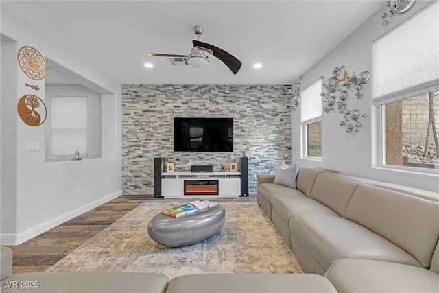 living room featuring hardwood / wood-style flooring, a fireplace, and ceiling fan