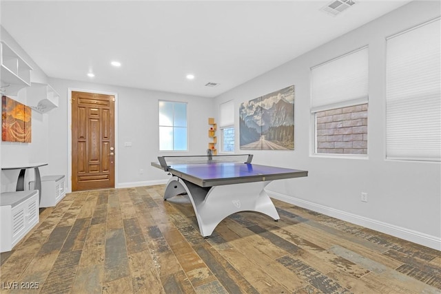 game room with dark wood-type flooring