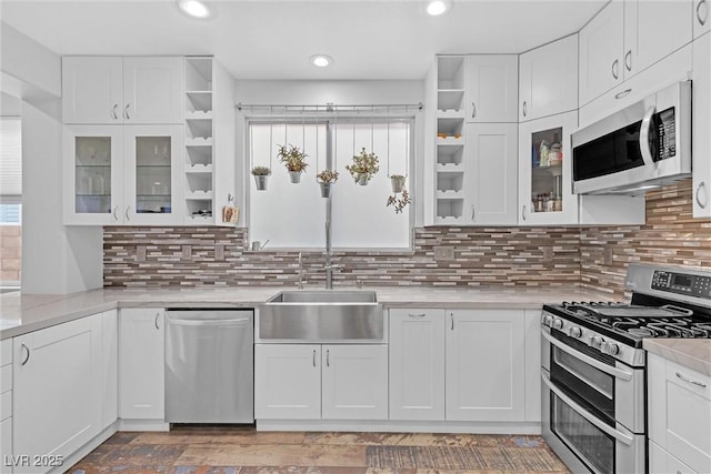 kitchen featuring white cabinetry, stainless steel appliances, sink, and tasteful backsplash