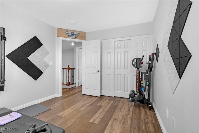 exercise room with hardwood / wood-style floors