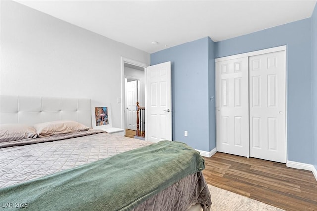 bedroom featuring dark hardwood / wood-style floors and a closet