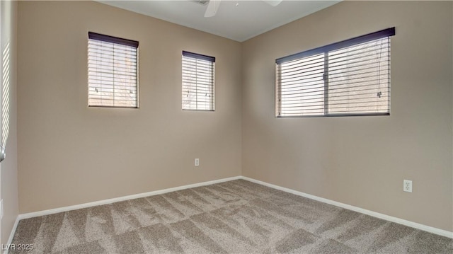 carpeted empty room featuring ceiling fan