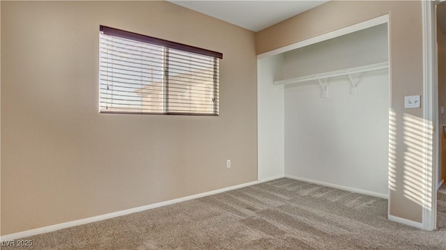 unfurnished bedroom with carpet flooring and a closet