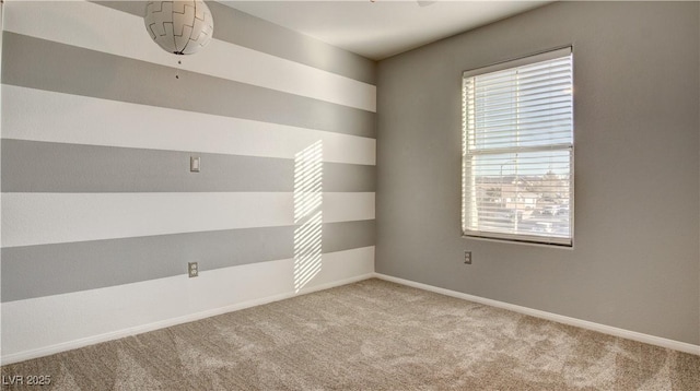 empty room featuring plenty of natural light and light carpet