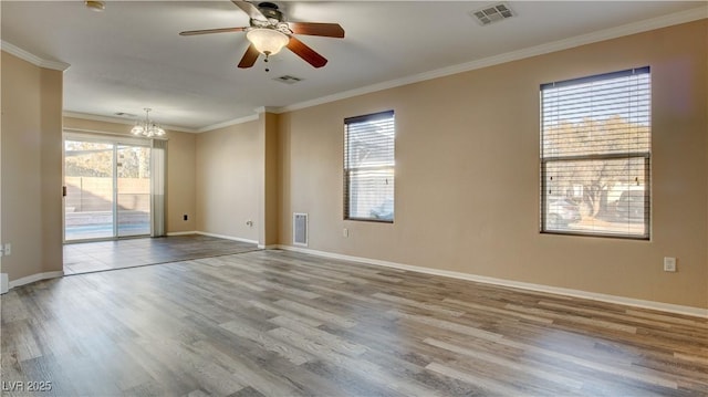 unfurnished room with ornamental molding, ceiling fan with notable chandelier, and wood-type flooring