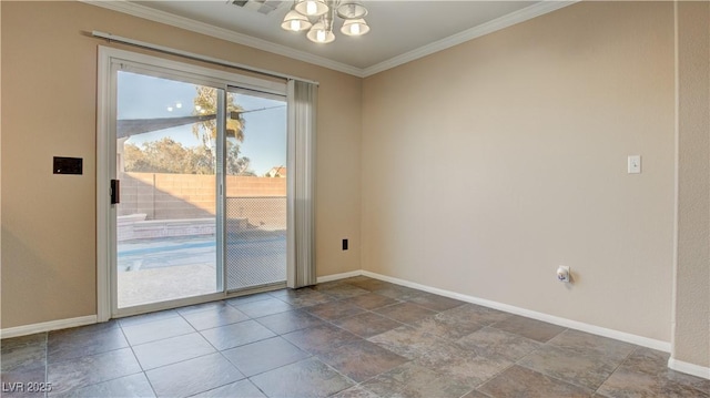 spare room featuring crown molding and a chandelier