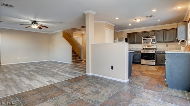 kitchen with stainless steel appliances, ornamental molding, dark brown cabinetry, and ceiling fan