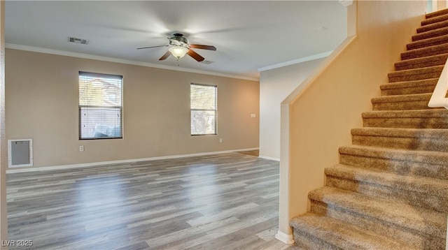 interior space featuring hardwood / wood-style flooring, ceiling fan, and ornamental molding