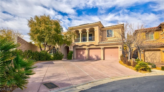 mediterranean / spanish-style house with a garage