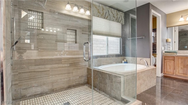 bathroom featuring vanity and separate shower and tub