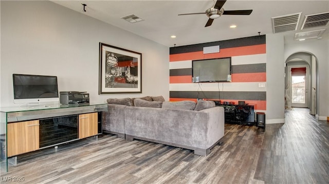 living room with dark hardwood / wood-style flooring and ceiling fan