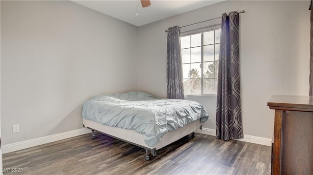 bedroom with dark hardwood / wood-style floors and ceiling fan