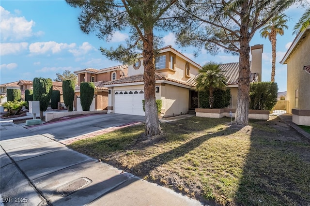 mediterranean / spanish-style home with a garage and a front yard