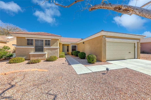 single story home featuring concrete driveway, an attached garage, and stucco siding