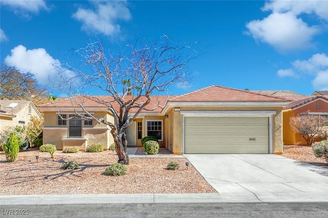 single story home featuring a garage, a tile roof, concrete driveway, and stucco siding