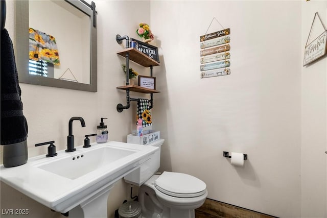 bathroom featuring toilet and sink