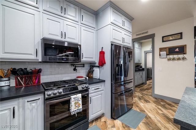 kitchen featuring white cabinetry, appliances with stainless steel finishes, backsplash, and light wood-type flooring