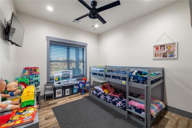 bedroom with hardwood / wood-style flooring and ceiling fan