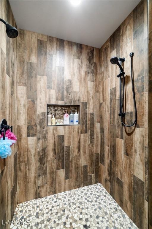 bathroom with a tile shower