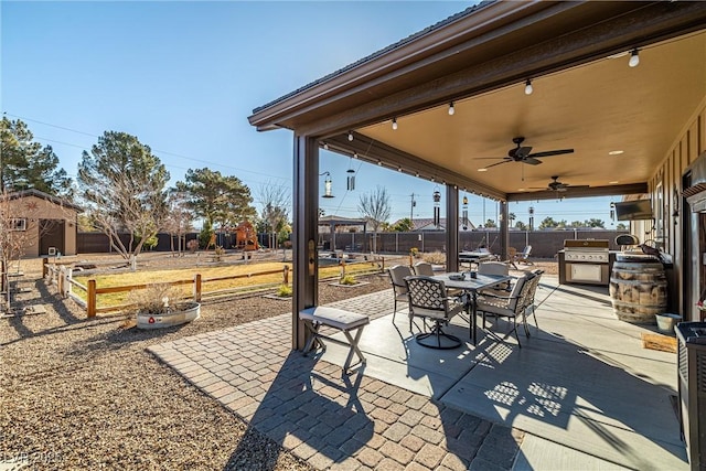 view of patio / terrace featuring exterior kitchen, area for grilling, and ceiling fan