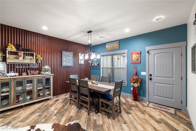 dining space with a chandelier and hardwood / wood-style floors