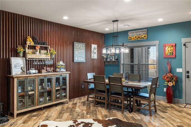 dining space with hardwood / wood-style floors