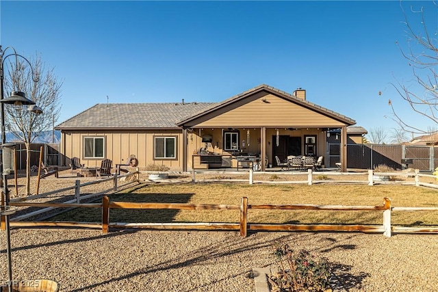 back of property with a patio