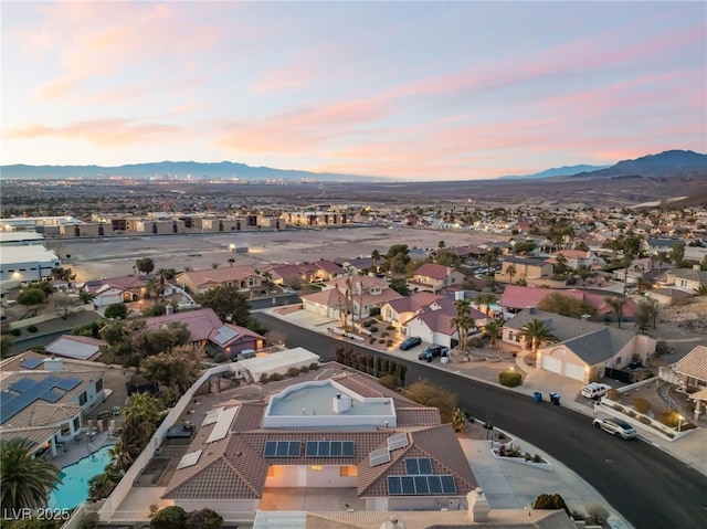 aerial view at dusk featuring a mountain view