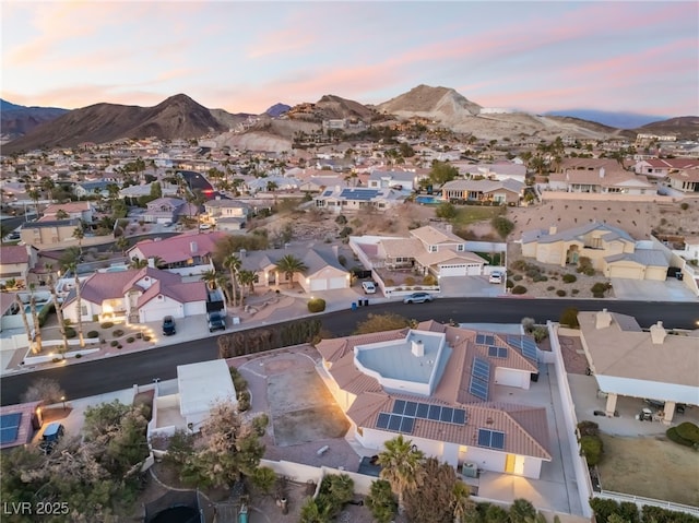 aerial view at dusk featuring a mountain view