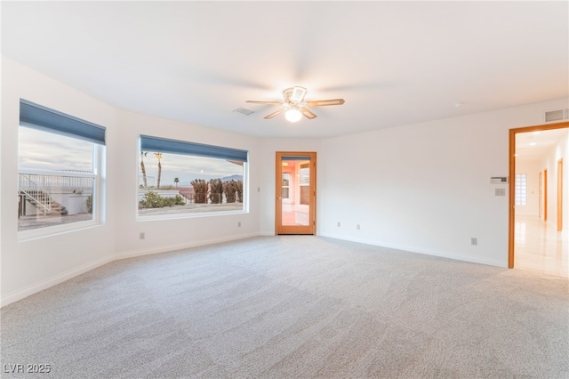 unfurnished room featuring light colored carpet and ceiling fan